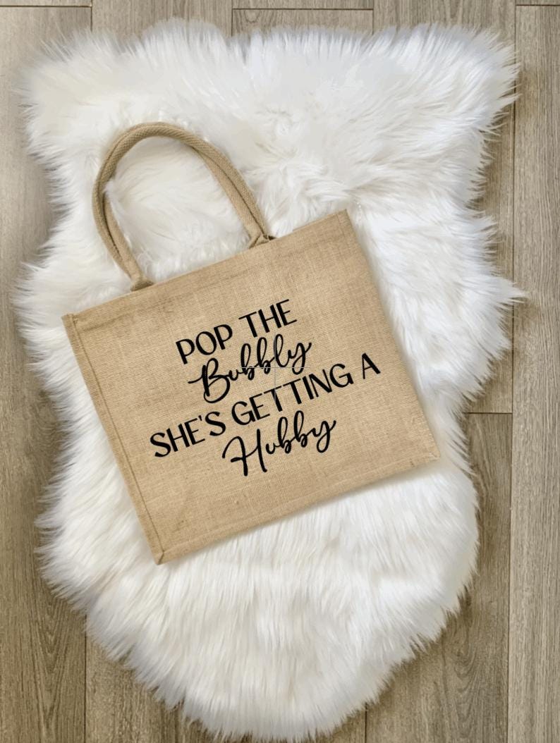 Pop The Bubbly She’s Getting A Hubby Jute Tote Bag - Custom Bridal Shower Gift, Bachelorette Party Welcome Bag, Rustic Wedding Gift for Bride, Hen Party Bag, Personalized Burlap Beach Tote, Champagne Lovers Gift, Bride to Be Accessory